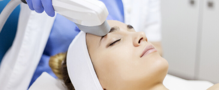 woman getting laser skin tightening laying down with her eyes closed